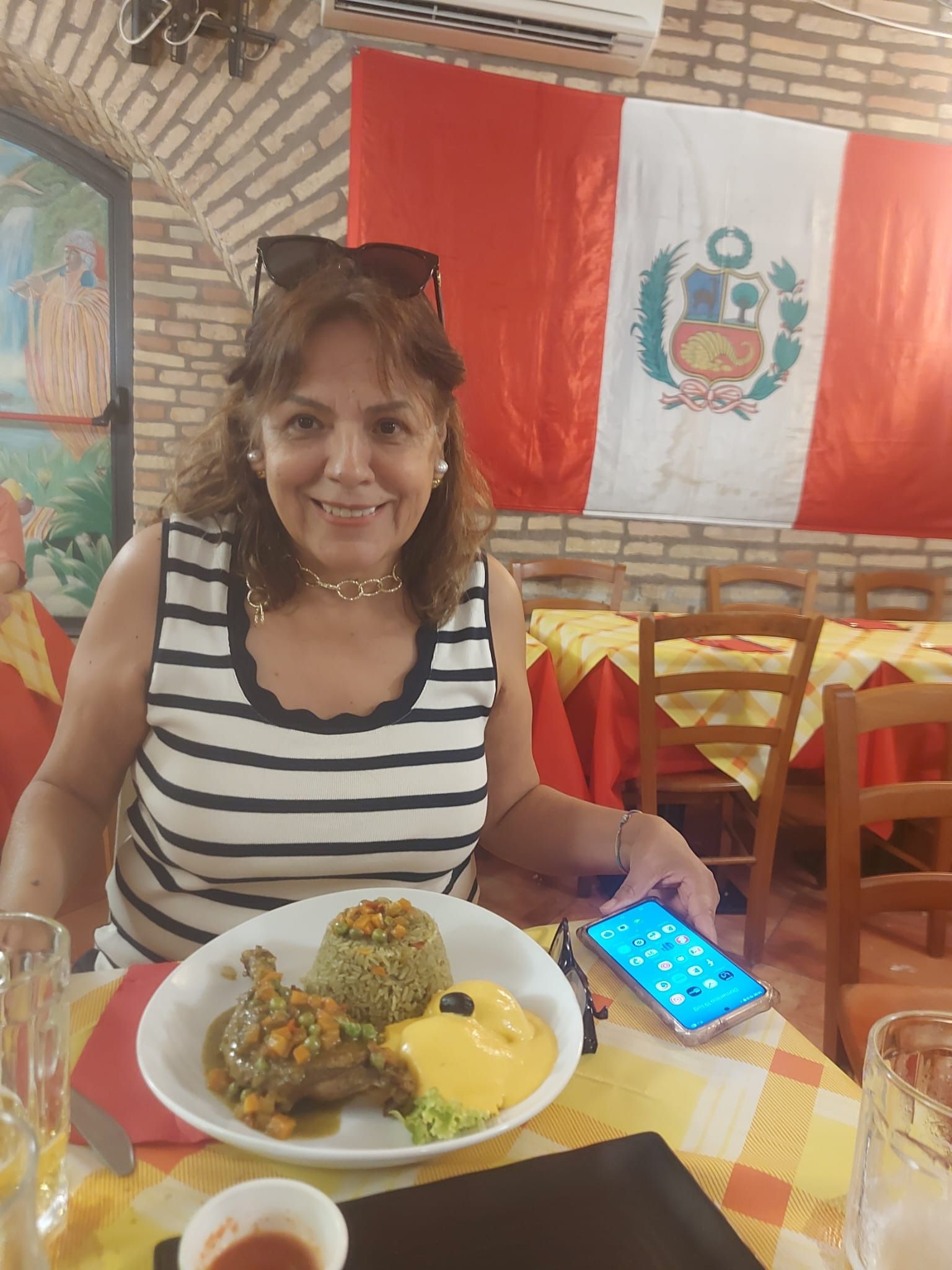 María at a Peruvian restaurant under the Peruvian flag