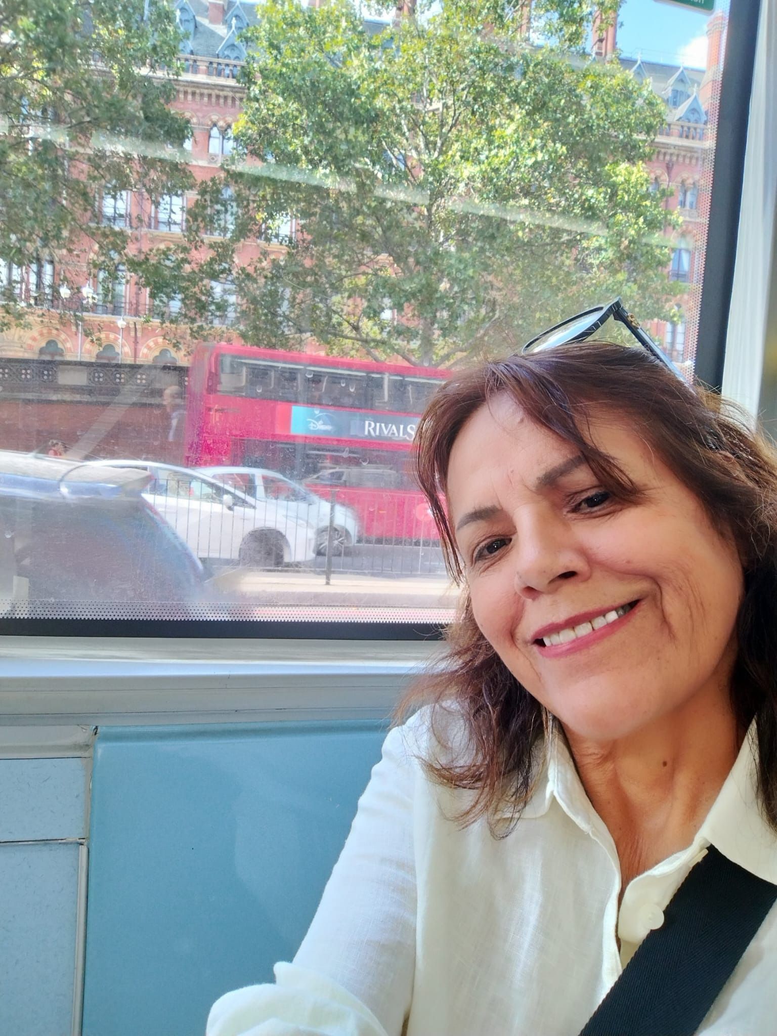 María smiling by a window